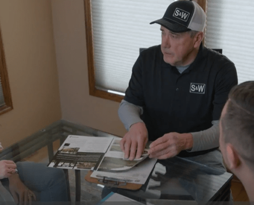 Sales representative with customer showing fence options