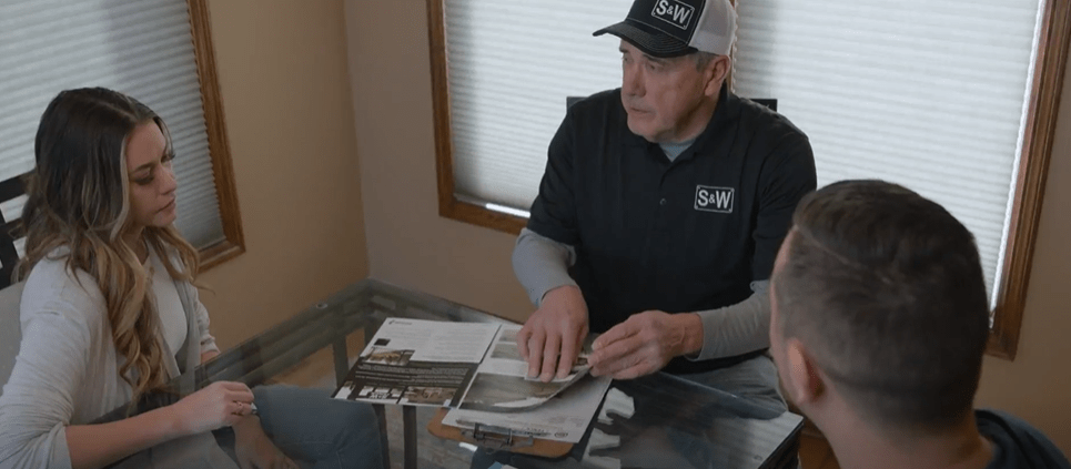 Sales representative with customer showing fence options